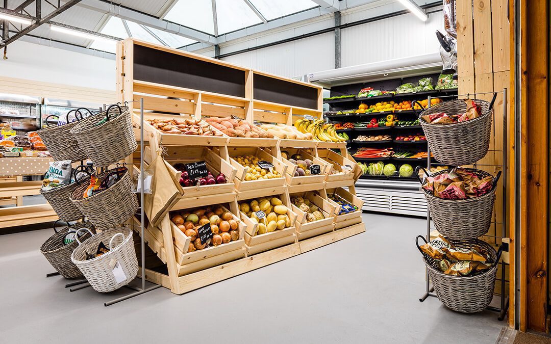 A view across the new farm shop at a garden centre showing the fresh produce on dispaly in custom built wooden displays