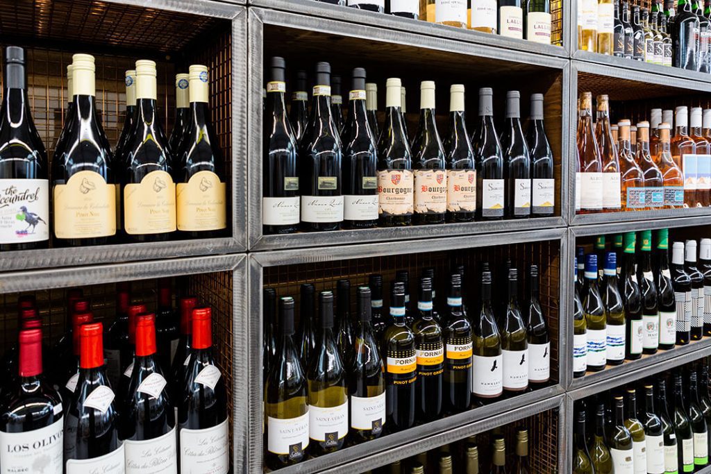 A view of the wine selection on shelves at a garden centre farm shop.