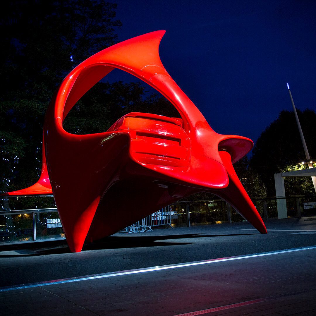 A striking image of a futuristic looking sculpture of a vehicle on the Southbank in London