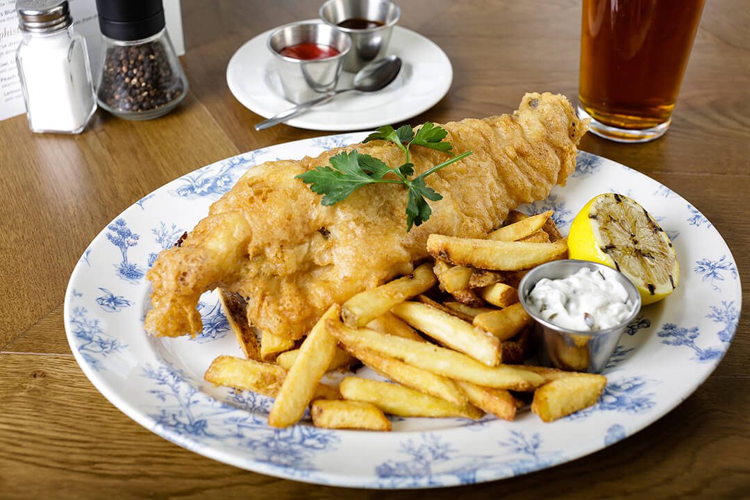 A plate of traditional fish and chips taken as part of a marketing shoot for pub food