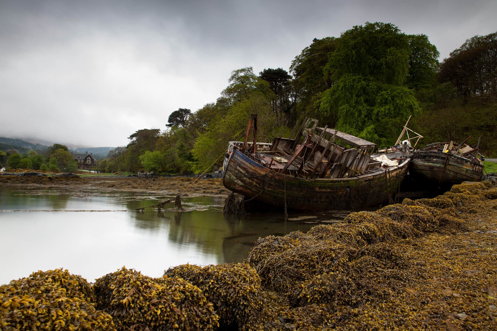 Abandoned fishing boats with seaweed in the foreground at Salen on the Isle of Mull