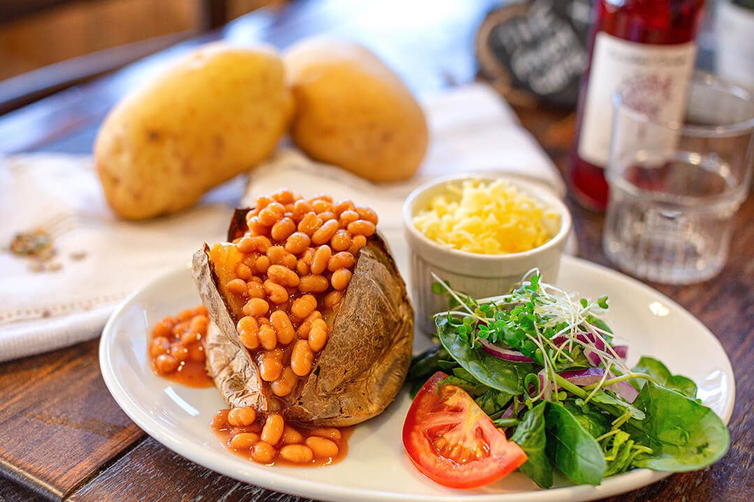 Posh looking jacket potato with beans cheese and a healthy looking salad.