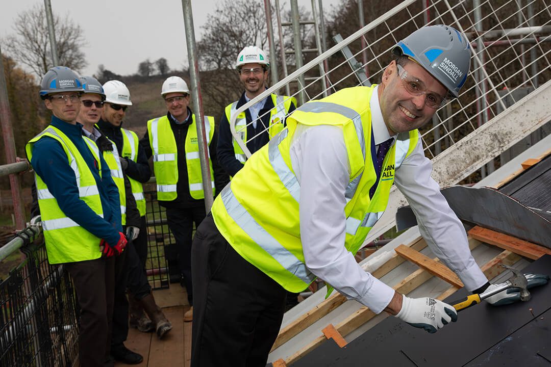 Image celebrating the topping out of a school development in Surrey by Morgan Sindall construction.